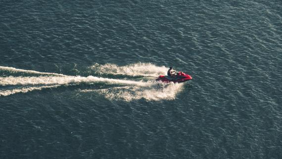 A man riding a jetski across the water